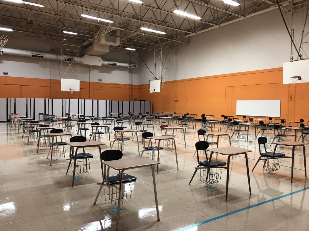 Desks are set up six feet apart in the gym at Navarro Middle School.