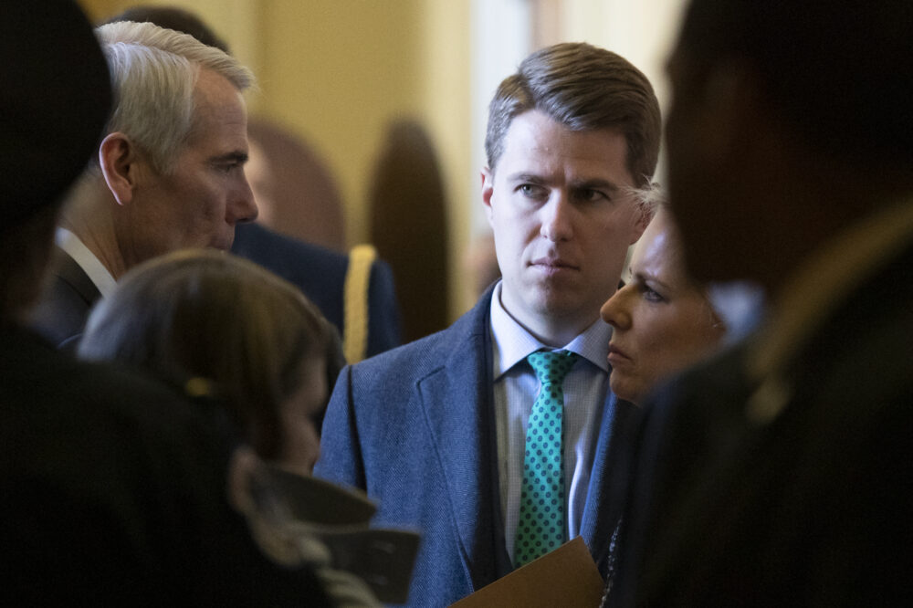 In this March 5, 2019, photo, Sen. Rob Portman, R-Ohio, left, talks with Homeland Security Secretary Kirstjen Nielsen, right, and her chief of staff Miles Taylor depart after the Republican Caucus luncheon on Capitol Hill in Washington. Taylor who penned a scathing anti-Trump op-ed and book under the pen name 