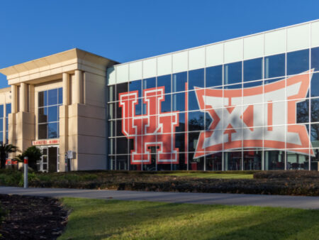 A large UH logo and Big 12 Conference Logo are seen next to each other on the front of the UH Athletics/Alumni Center