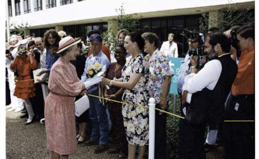 Queen Elizabeth II accepts a bouquet of flowers during her 1991 visit to the Johnson Space Center. 